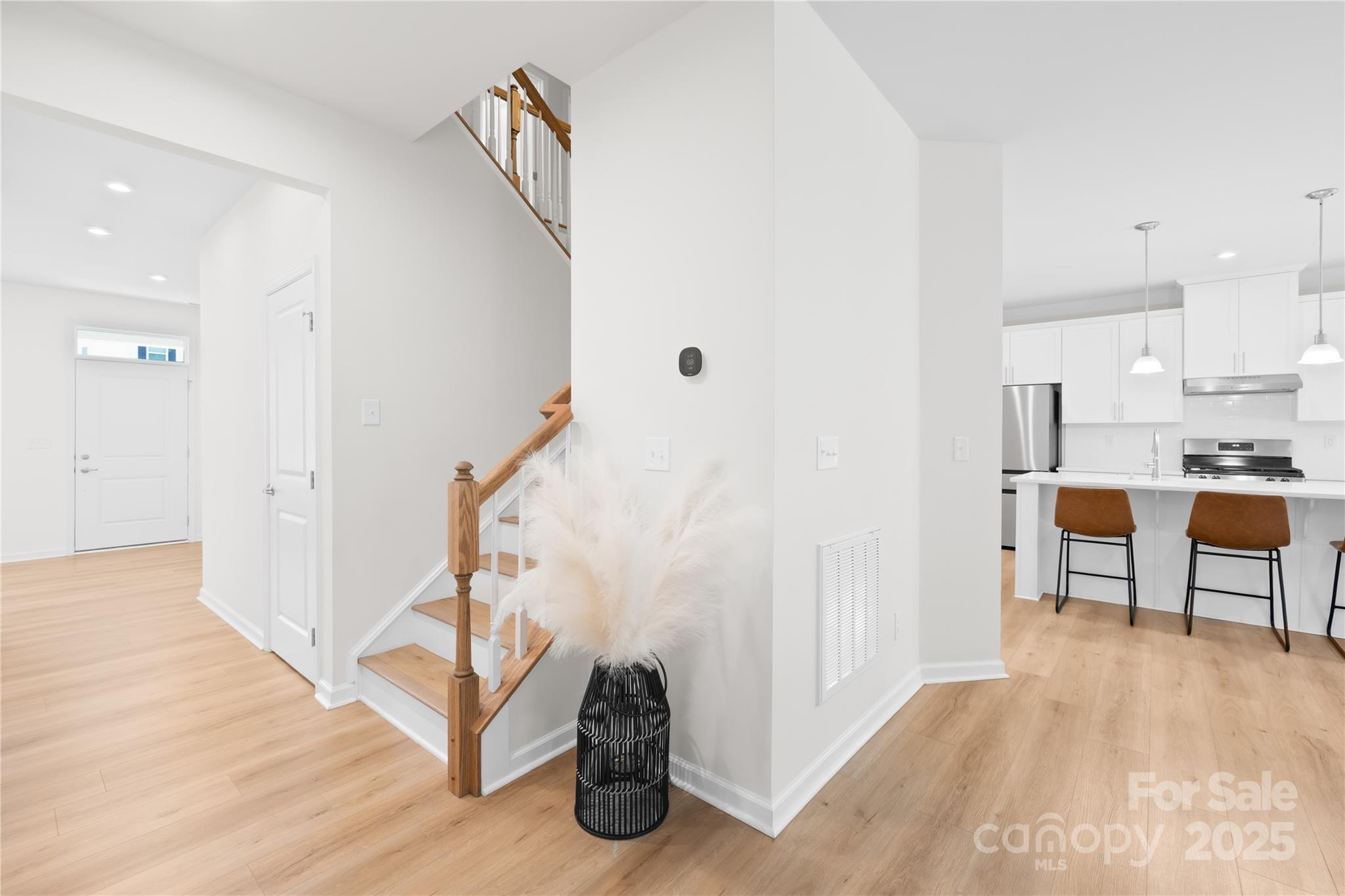 3110 Streamside Drive Davidson, NC 28036 - Photo 4 of 39 a view of a kitchen with furniture and wooden floor