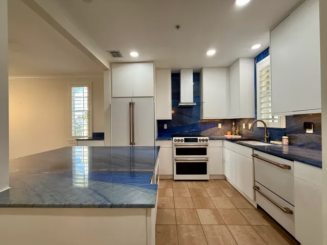 a kitchen with stainless steel appliances granite countertop a stove and a sink