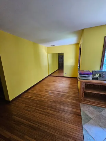 a view of room with furniture and wooden floor