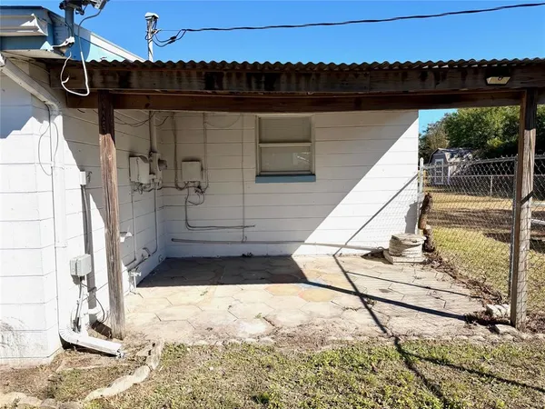 a view of a balcony with wooden floor and iron fence
