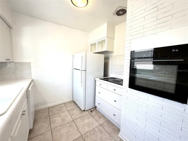a kitchen with a refrigerator and a stove