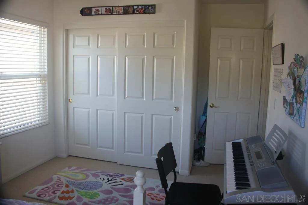 1467 Beechtree Road San Marcos, CA 92078 - Photo 5 of 8 a view of a livingroom with furniture and a window