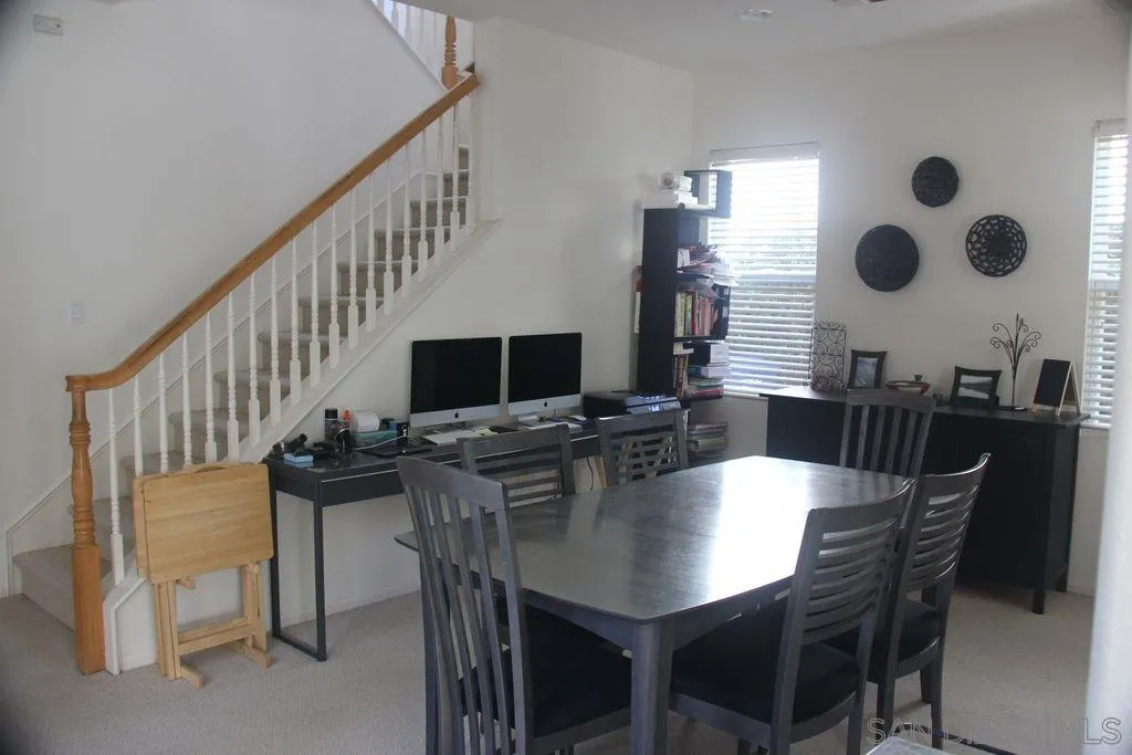 1467 Beechtree Road San Marcos, CA 92078 - Photo 7 of 8 a view of a dining room with furniture and a large mirror