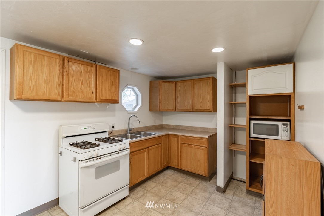 7370 Enterprise Road Ferndale, WA 98248 - Photo 14 of 25 a kitchen with a sink stove and microwave