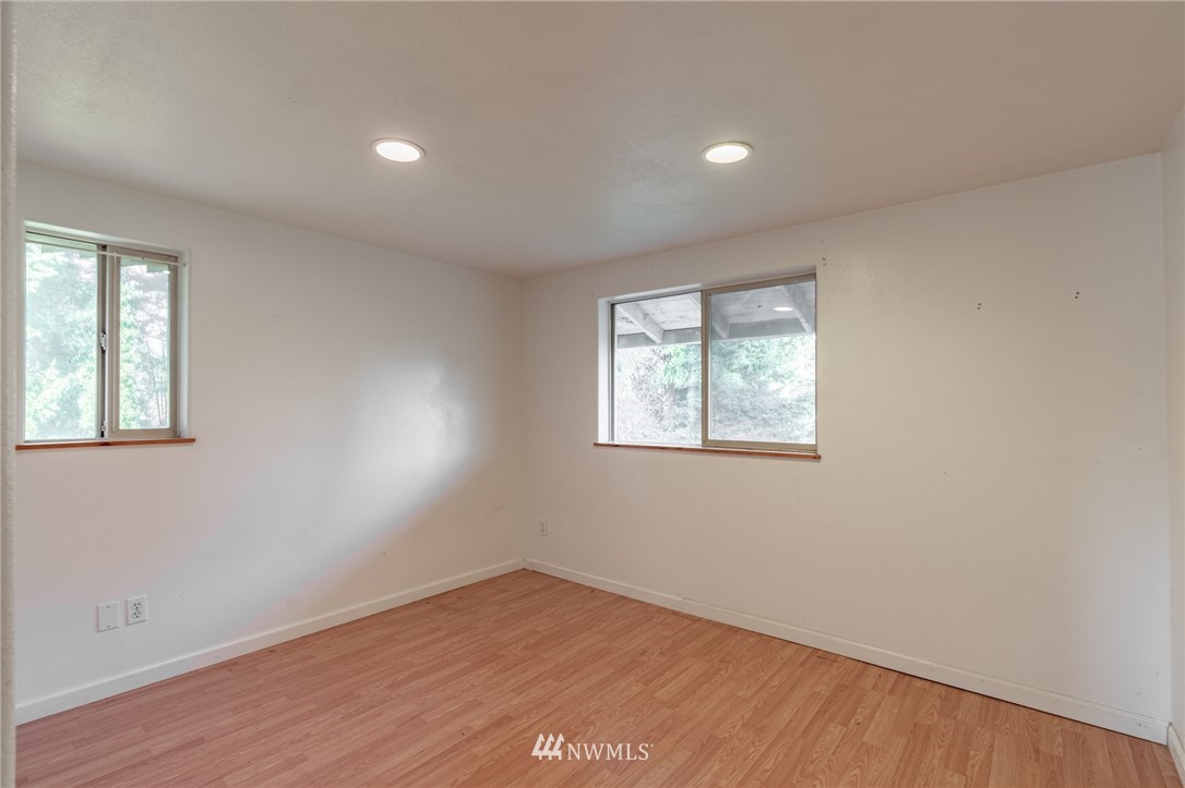 7370 Enterprise Road Ferndale, WA 98248 - Photo 23 of 25 an empty room with wooden floor and windows