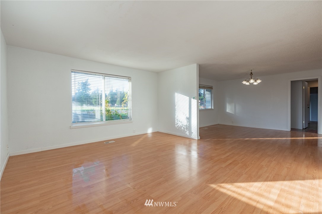 7370 Enterprise Road Ferndale, WA 98248 - Photo 5 of 25 an empty room with wooden floor and windows