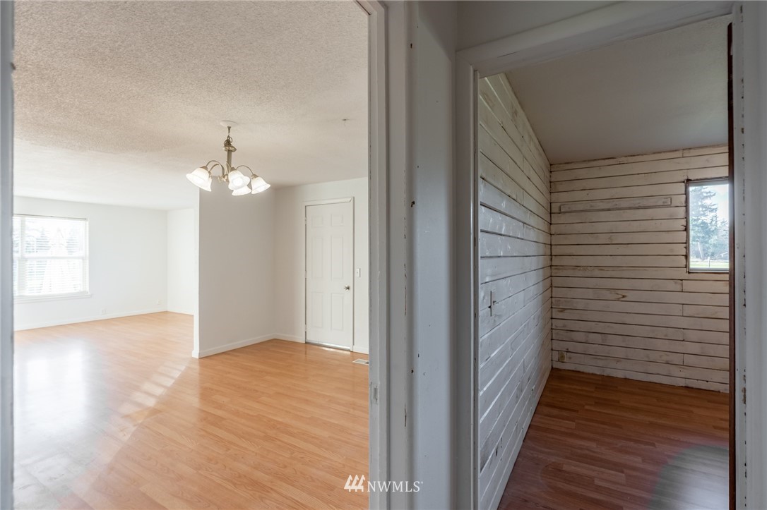 7370 Enterprise Road Ferndale, WA 98248 - Photo 8 of 25 a view of a hallway with wooden floor and staircase