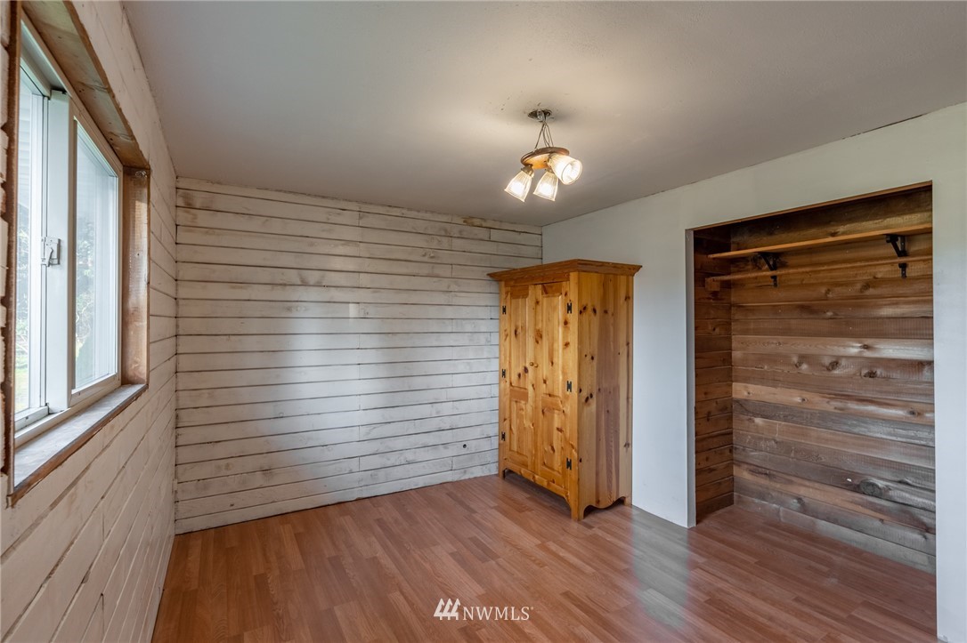 7370 Enterprise Road Ferndale, WA 98248 - Photo 9 of 25 an empty room with wooden floor closet and windows