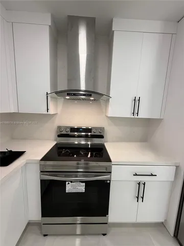 a stove top oven sitting inside of a kitchen