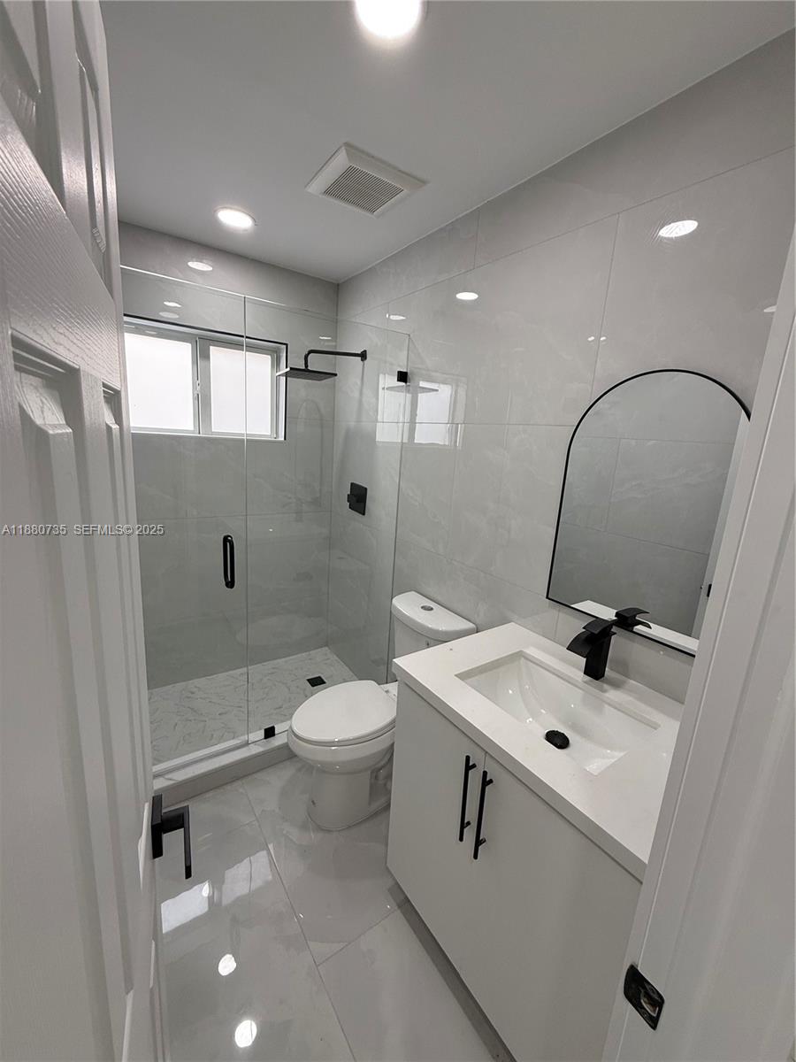 841 West 50th Street, Unit 2 Hialeah, FL 33012 - Photo 7 of 12 a bathroom with a sink toilet and shower