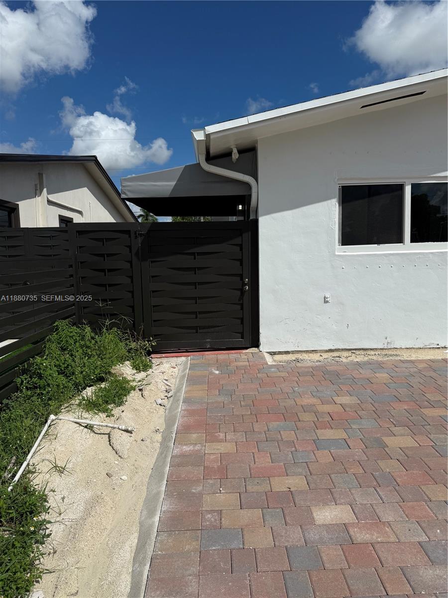 841 West 50th Street, Unit 2 Hialeah, FL 33012 - Photo 8 of 12 a front view of a house with a garage