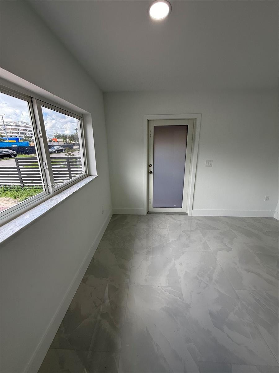 841 West 50th Street, Unit 2 Hialeah, FL 33012 - Photo 9 of 12 an empty room with a window