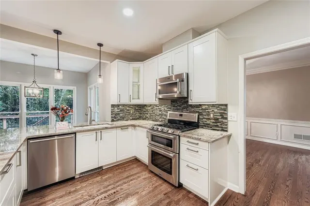 a kitchen with a sink stove and microwave