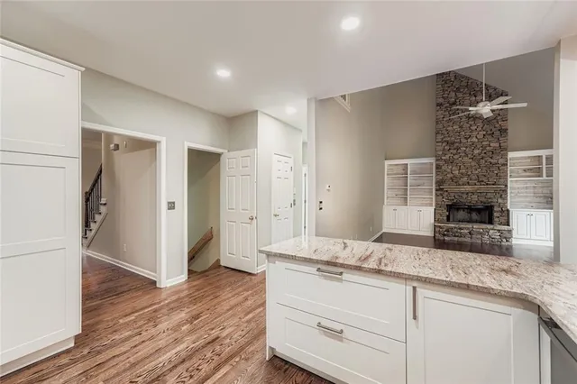 a bathroom with a granite countertop sink mirror and shower