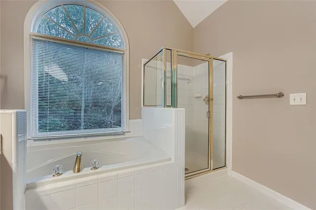 a bathroom with a bathtub and shower