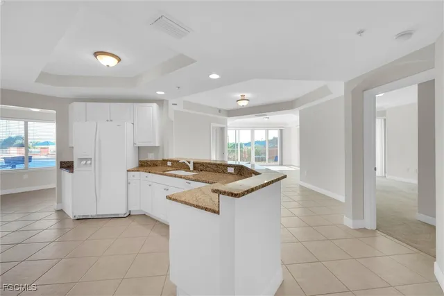 a kitchen that has a sink a stove and a refrigerator