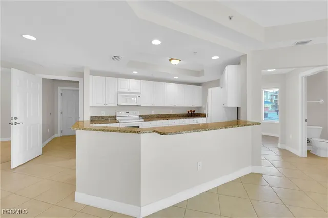 a kitchen with granite countertop a stove a sink and a granite counter tops