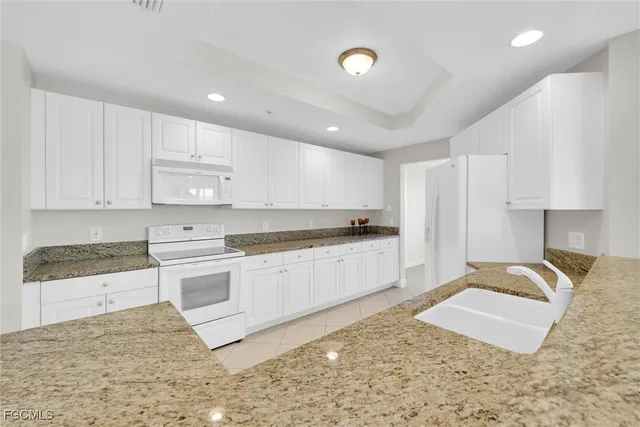a bathroom with a granite countertop double sink and mirror