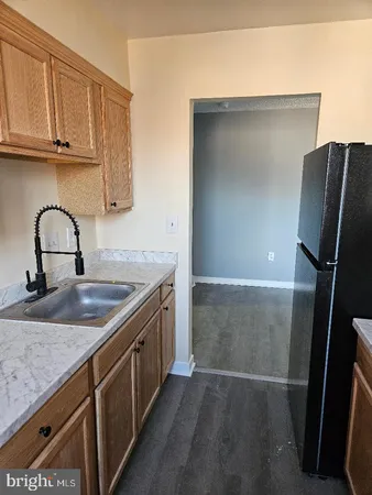 a kitchen with a refrigerator and a sink