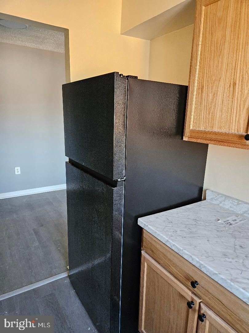 10 Halley Place Southeast, Unit 203 Washington, DC 20032 - Photo 12 of 13 a kitchen with a refrigerator and a sink