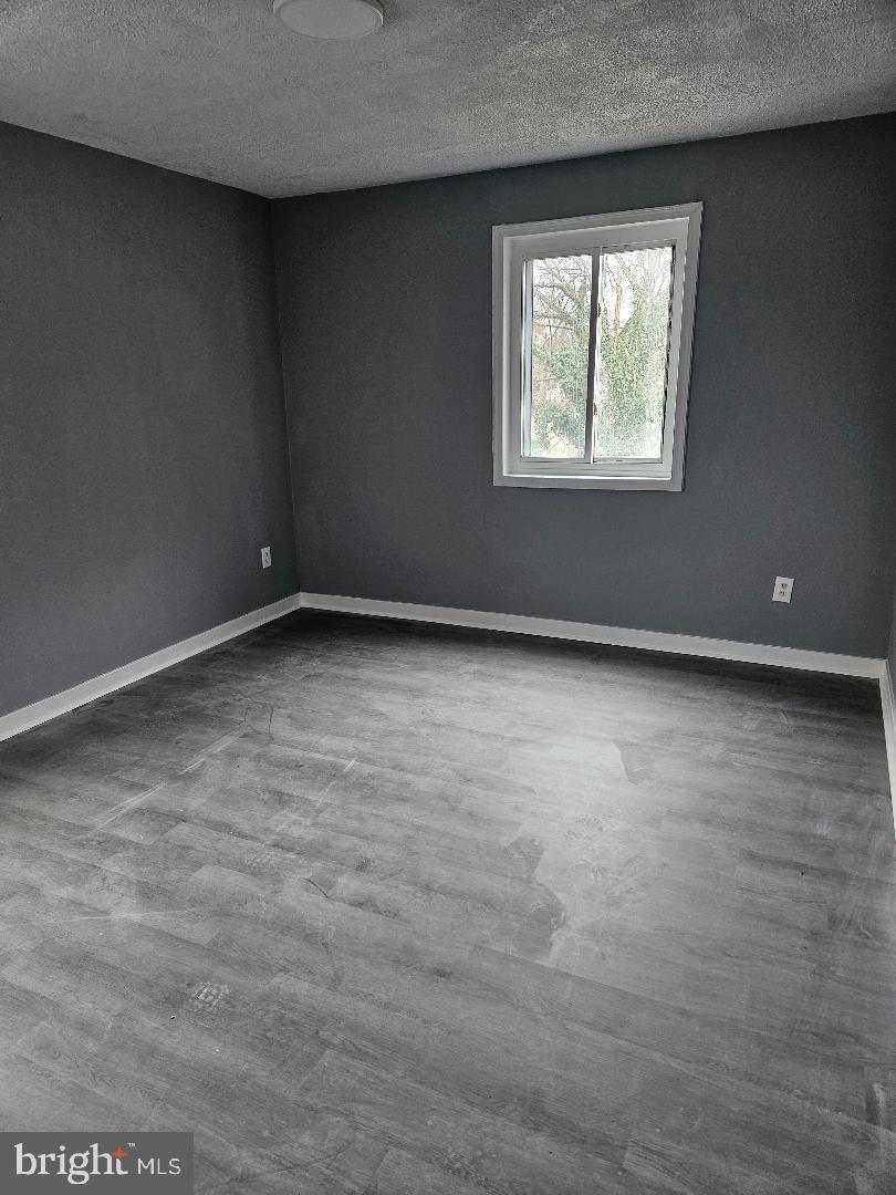 10 Halley Place Southeast, Unit 203 Washington, DC 20032 - Photo 9 of 13 an empty room with windows