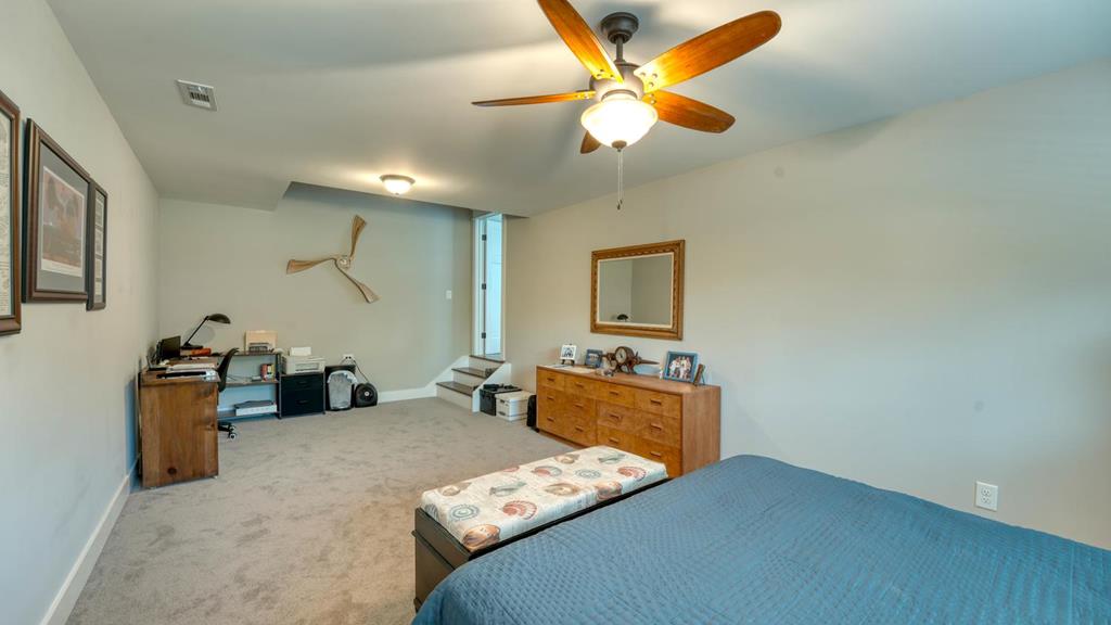 31 Elf School Road Hayesville, NC 28904 - Photo 49 of 59 a bedroom with furniture and a chandelier