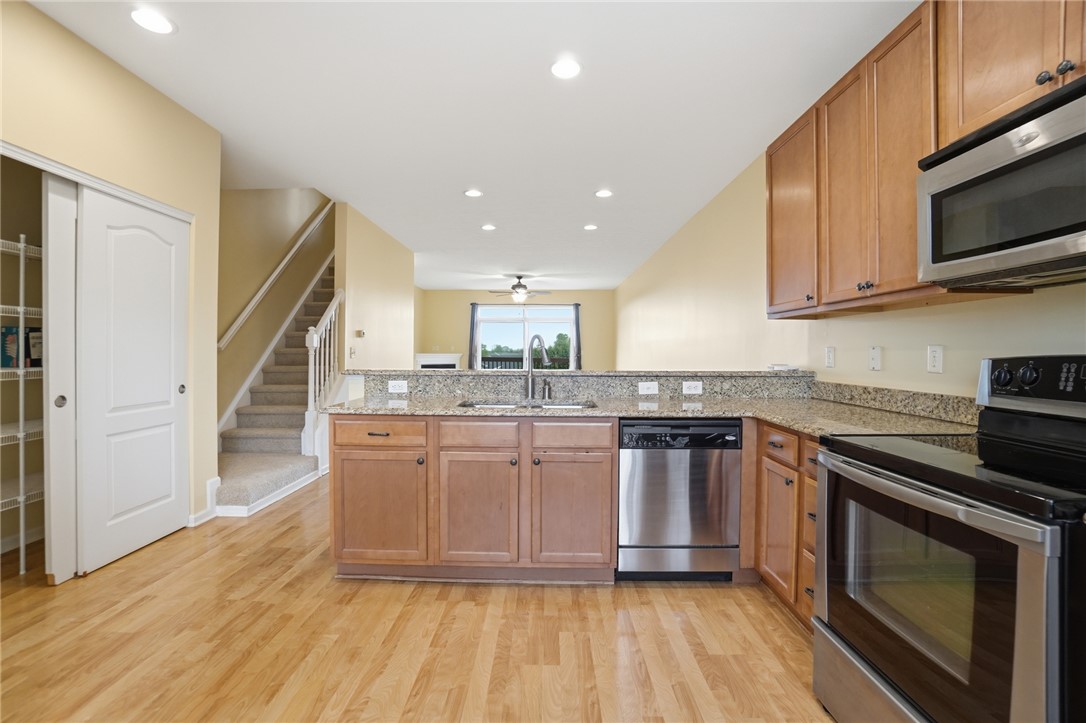 4324 Straight Arrow Road Dayton, OH 45430 - Photo 8 of 40 This spacious kitchen offers ample granite counter space, modern appliances, and a seamless flow into the living area.