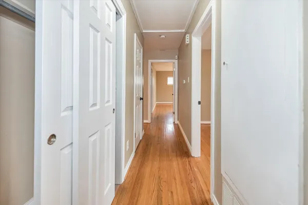 a view of a hallway with wooden floor