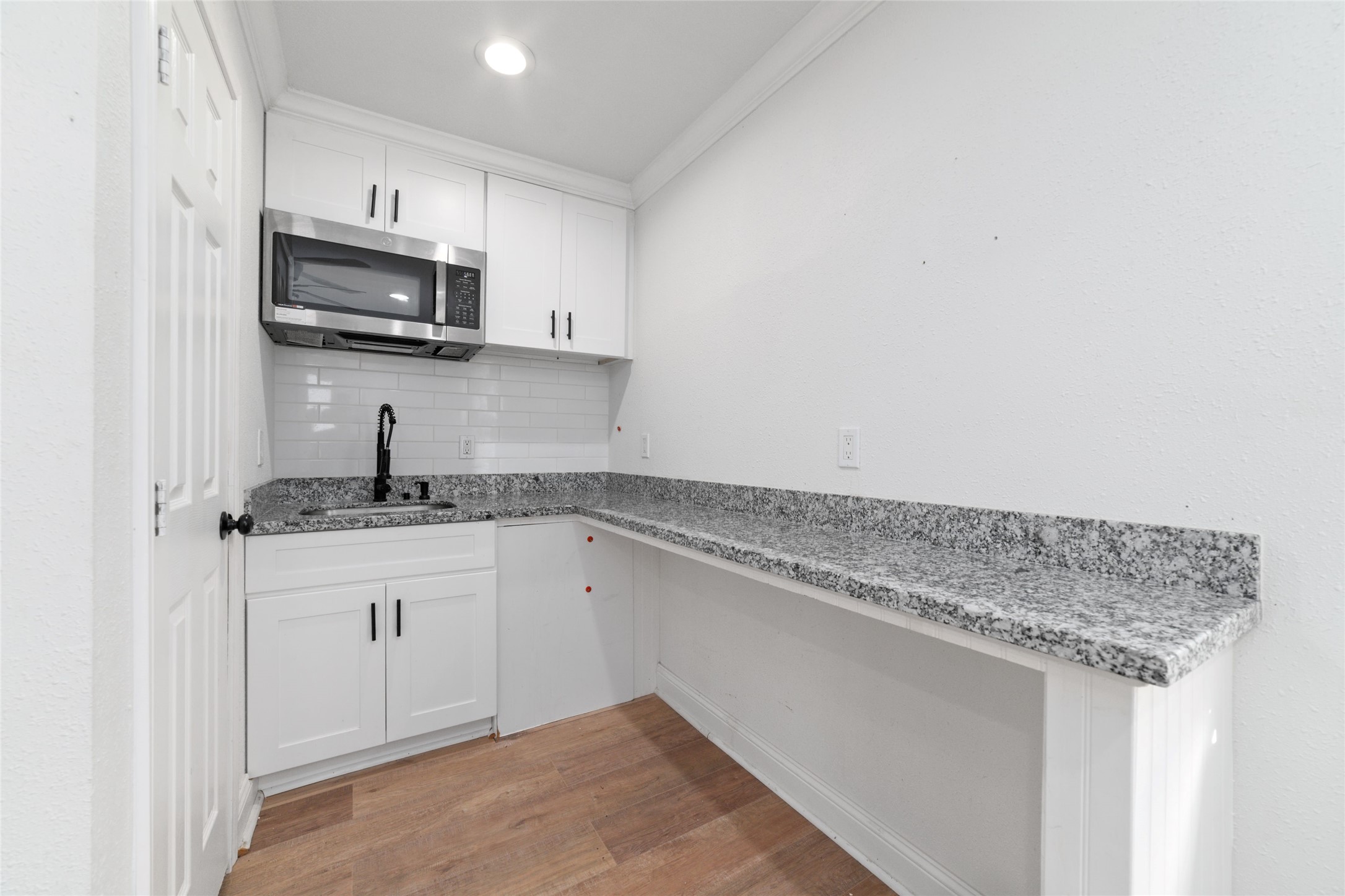 7125 Conley Street Houston, TX 77021 - Photo 26 of 32 Mini kitchen space with a microwave and a sink.