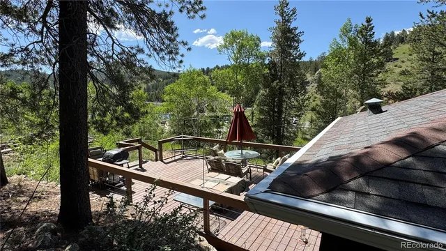 a view of a balcony with two chairs and a table