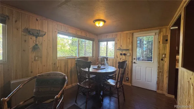 a view of a dining room with furniture and window