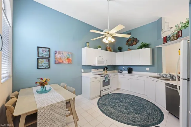 a kitchen with a stove a table and chairs