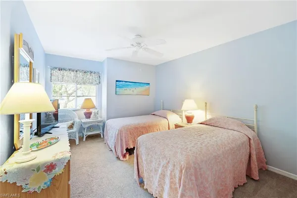 a bedroom with two beds and a chandelier