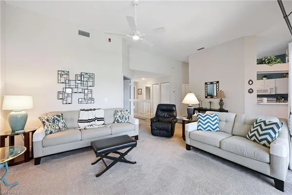 a living room with furniture and a night stand