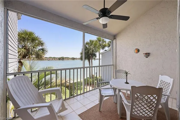 a view of a chairs and table in the balcony