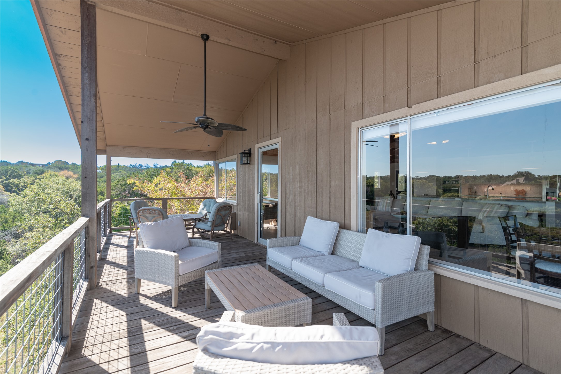 3807 Boat Dock Road Lago Vista, TX 78645 - Photo 22 of 37 Perched above the tree canopy, this expansive deck offers an idyllic retreat for outdoor living and dining.