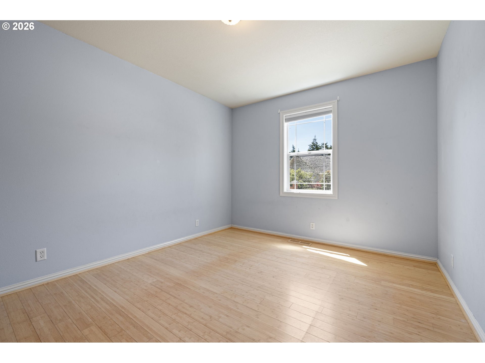 2218 Willow Loop Florence, OR 97439 - Photo 22 of 47 an empty room with wooden floor and windows