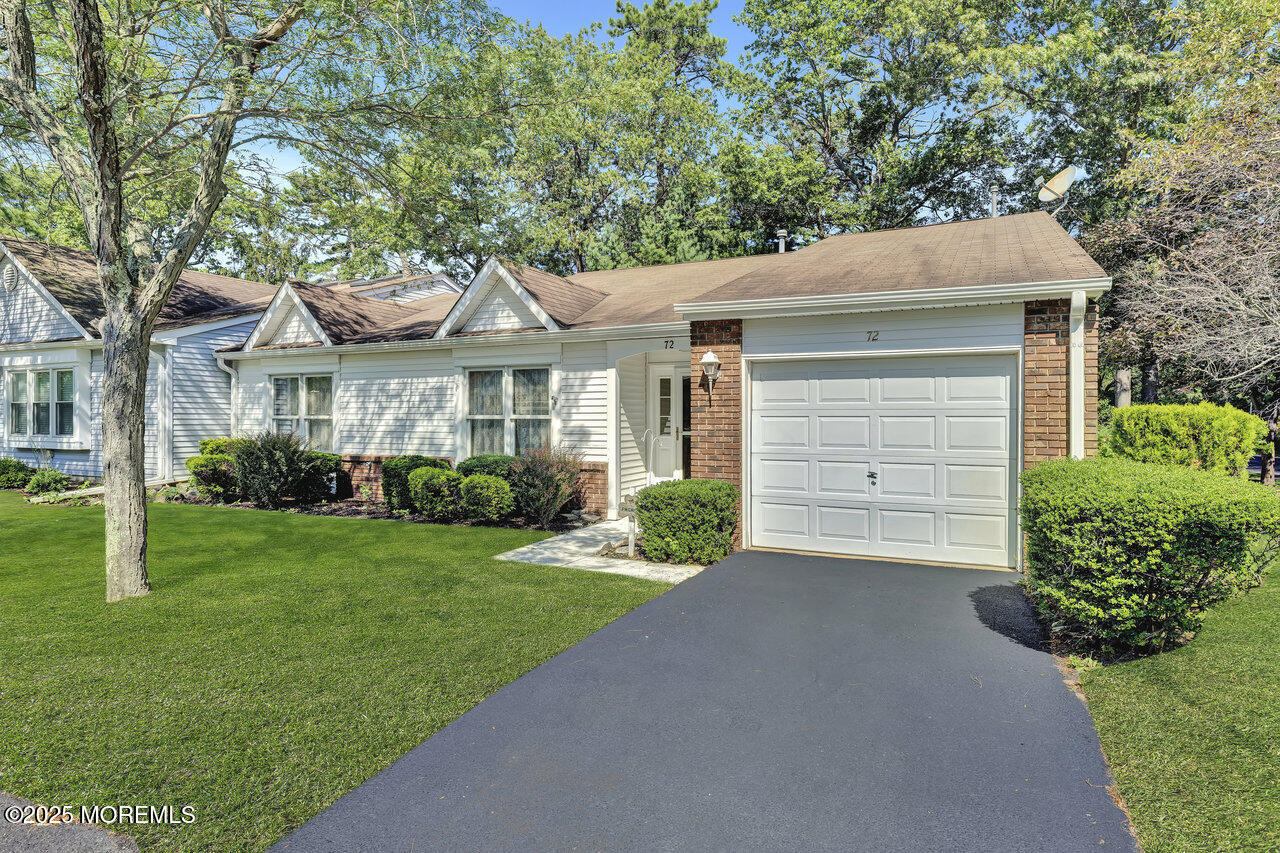 72 Jean Street Lakewood, NJ 08701 - Photo 11 of 34 a front view of a house with a yard and garage