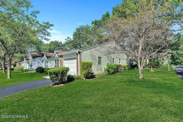 a front view of a house with a garden and yard
