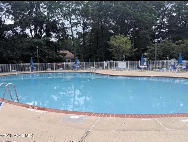 a view of a swimming pool with a patio