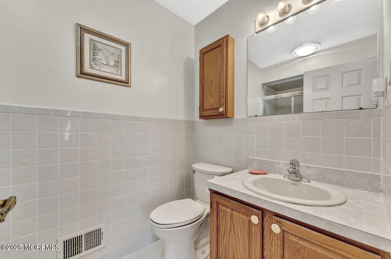72 Jean Street Lakewood, NJ 08701 - Photo 4 of 34 a bathroom with a sink and a toilet