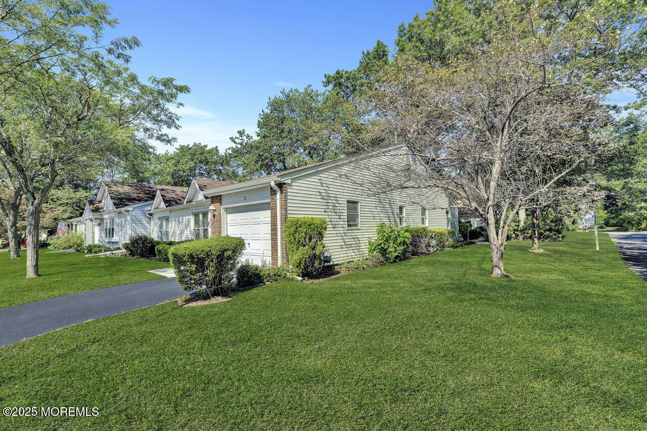 72 Jean Street Lakewood, NJ 08701 - Photo 5 of 34 a front view of a house with a garden and yard