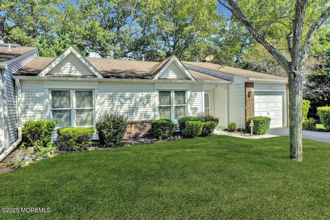 72 Jean Street Lakewood, NJ 08701 - Photo 10 of 34 a front view of a house with a yard and potted plants