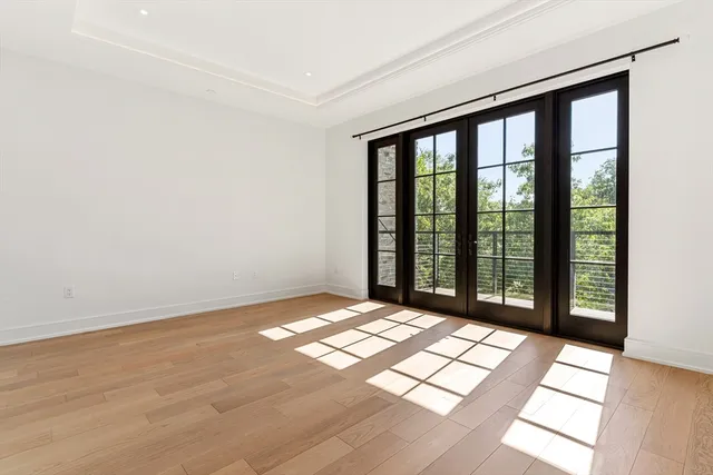 a view of an empty room with glass door