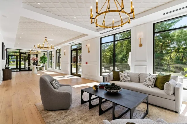 a living room with furniture and large windows