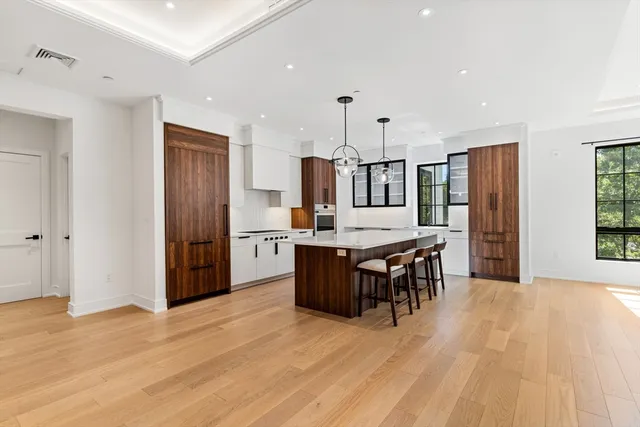 a large kitchen with a table and chairs