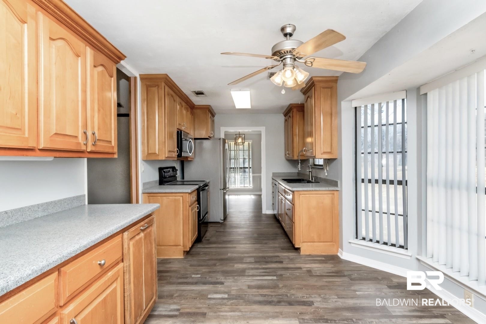 8304 Champlain Circle Mobile, AL 36695 - Photo 14 of 46 Kitchen with double oven range, dark hardwood / wood-style flooring, sink, and plenty of natural light