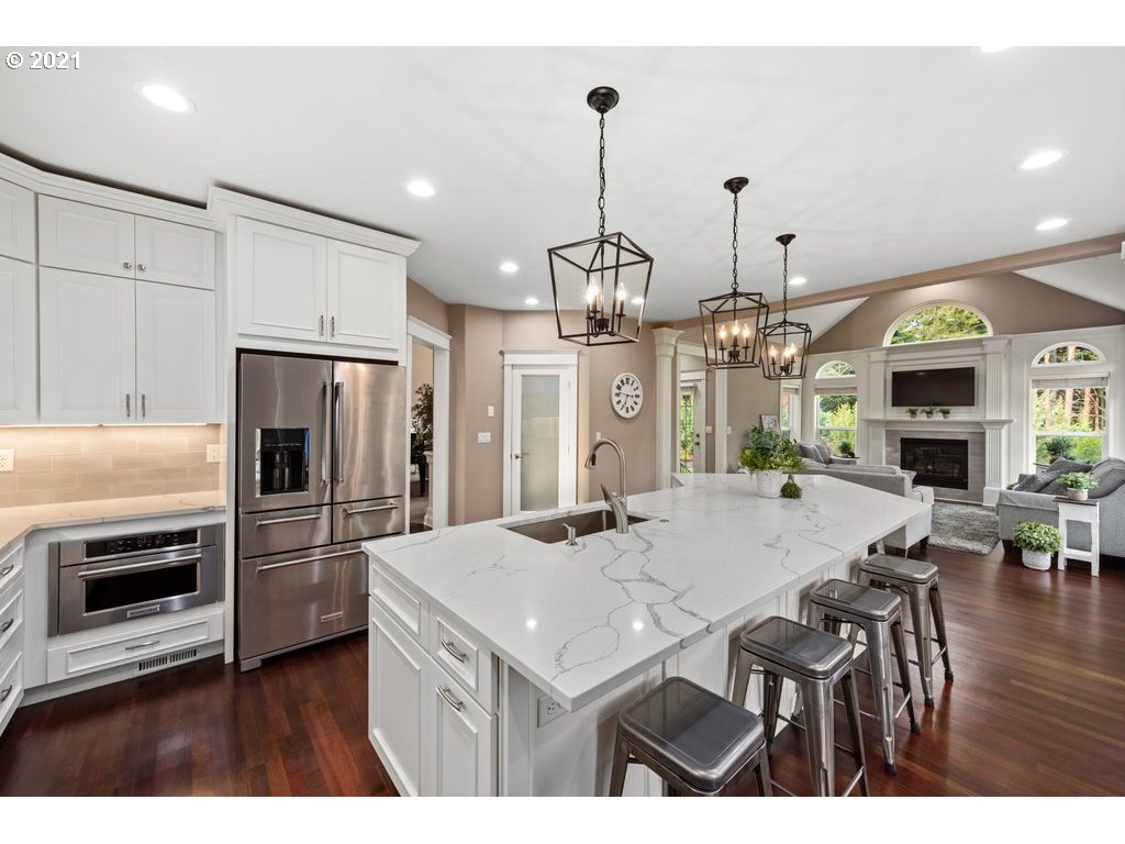 21892 South Ferguson Road Beavercreek, OR 97004 - Photo 12 of 32 a kitchen with stainless steel appliances kitchen island granite countertop a refrigerator a stove a microwave oven a sink with island and chairs