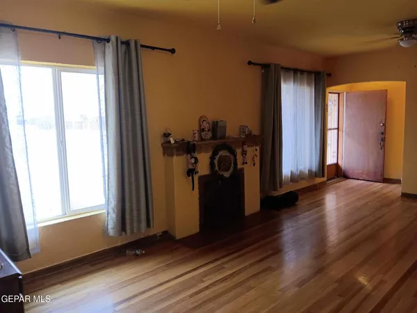 a view of a hallway with wooden floor and a window