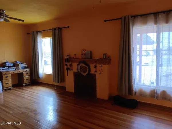 a view of a livingroom with wooden floor and a window